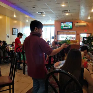 a man serving food to a group of people