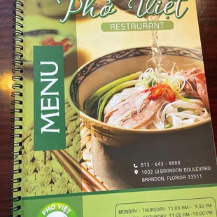 Front of the menu with their hours listed.