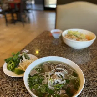 a bowl of soup and a plate of noodles