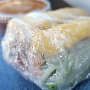 a sandwich wrapped in plastic wrap