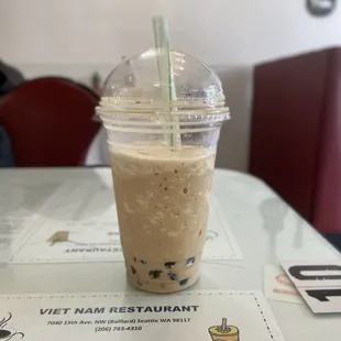 a drink in a plastic cup on a table