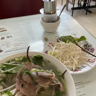 Pho with eye-round steak, brisket and tripe. Coffee with condensed milk.