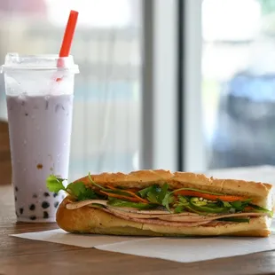 a sandwich and a drink on a table