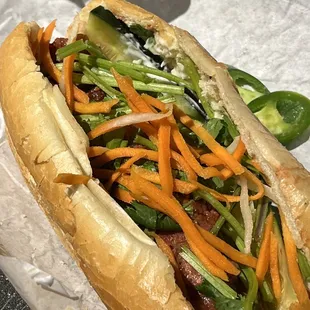 a hot dog with vegetables