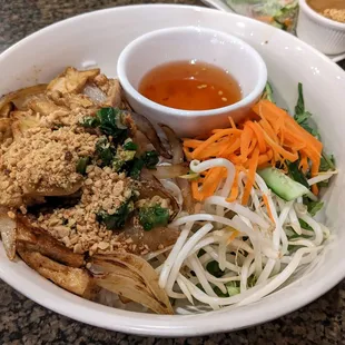 a bowl of noodles with meat and vegetables