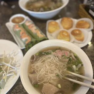 a bowl of pho vina with chopsticks on a table