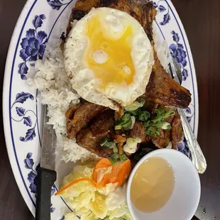 54. Pork  chop and charbroiled pork with broken rice AND an egg.
