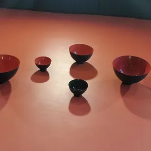 a group of red and black bowls
