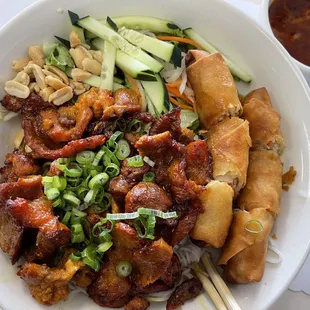 a bowl of food with chopsticks