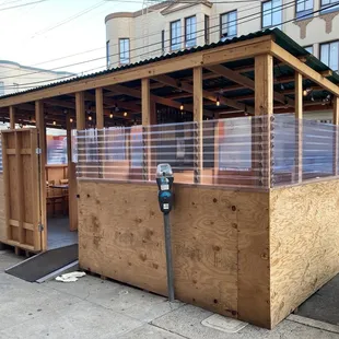 a parking meter in a wooden structure