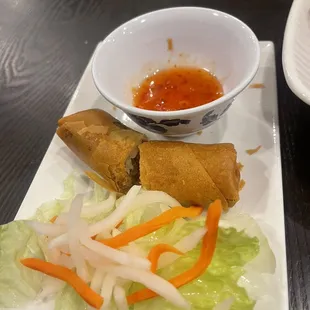 a plate of food and a bowl of dipping sauce