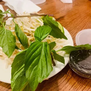 a plate of salad with basil leaves