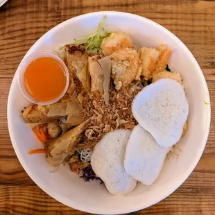 Bun Dac Biet - House Special Bowl ($14.50). Chicken, shrimp, and fried egg rolls with rice vermicelli and Vietnamese salad, shrimp chips.