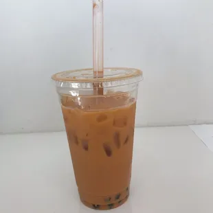 a cup of iced coffee with a straw