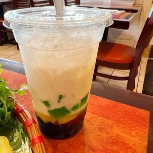 a drink in a plastic cup on a table