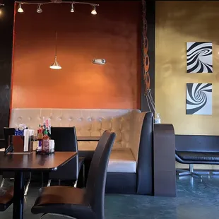 a dining area with a table and chairs