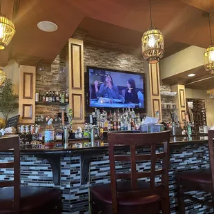 a bar with a television on the wall