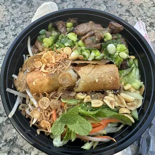 Pork noodles with crispy spring roll.