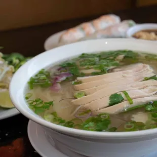 a bowl of soup with chicken and vegetables