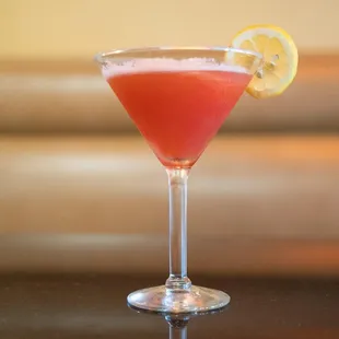 a pink cocktail in a coupe glass