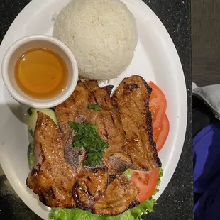 Com Suong Nuong Grilled Pork Chop #50.  2 larges pieces of pork chop pictured