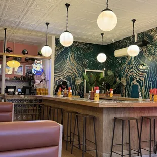 a restaurant with a bar and chairs