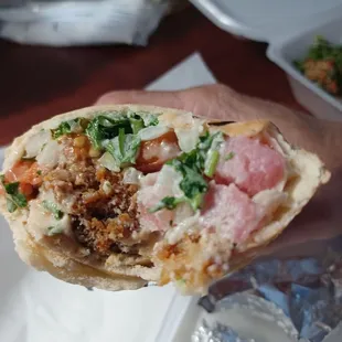 Half eaten falafel wrap.