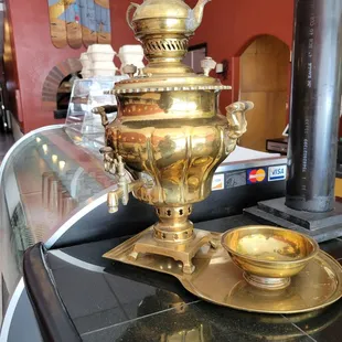 a golden teapot on a table