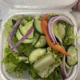 a salad in a styrofoam container