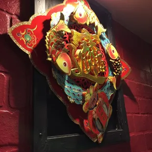 a red brick wall with a dragon head on it