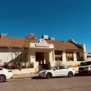 a row of parked cars in front of a building