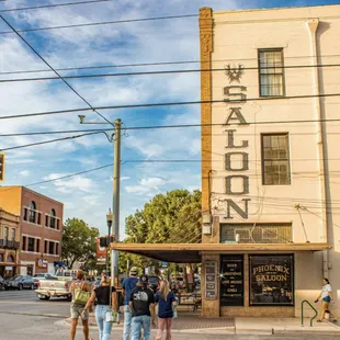 a group of people walking down the street