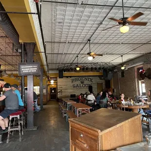 people sitting at tables in a restaurant