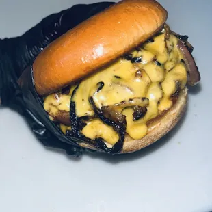 DEVIL&apos;S PRIDE. TWO 6OZ PATTIES SMOTHERED IN CHEDDAR WITH SAUTÉED ONION, BACON, AND CHIPOTLE SPREAD