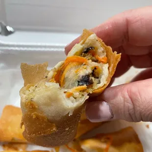 a hand holding a piece of food