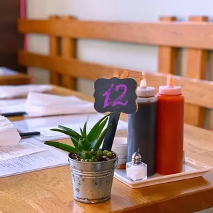 a wooden table with a small potted plant on it