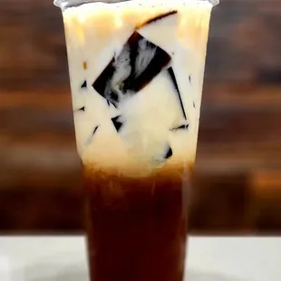 a cup of iced coffee on a table