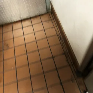 a view of a tiled floor in a bathroom