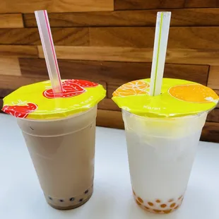 two drinks in plastic cups with straws