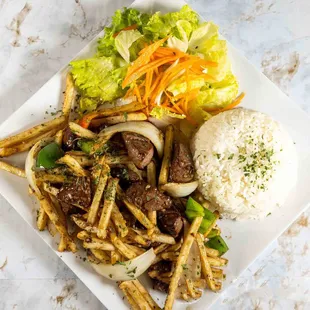Shaken Beef Filet mignon marinated in our special sauce sauteed with onions, bell peppers, tossed with French Fries. w/ rice, lettuce