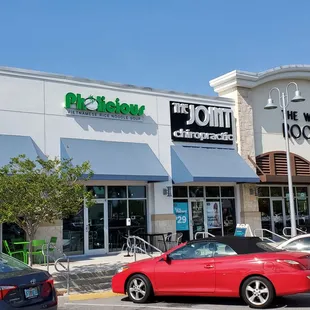 the front of a restaurant with cars parked in front of it