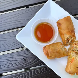 a plate of food with dipping sauce