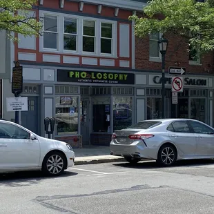 two cars parked in front of a store