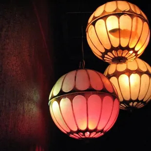 three lamps lit up in the dark