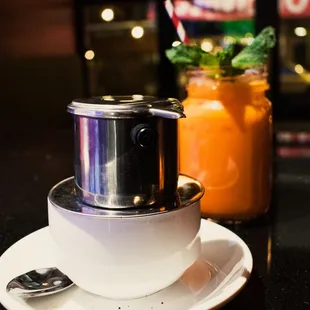 a cup of soup and a saucer on a plate