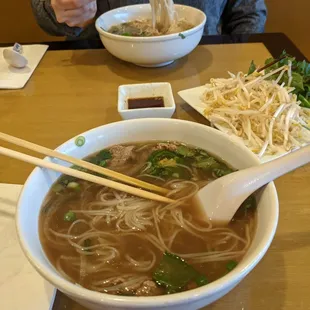 a bowl of soup and chopsticks