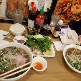Asian condiments waiting on the table. A good sign of good authentic pho place.