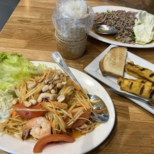 Papaya salad, chicken satay, larb, side order of sticky rice