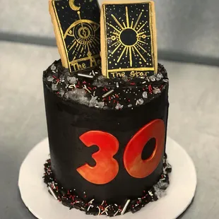a birthday cake with a tarot card on top