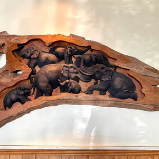 elephants carved into wood